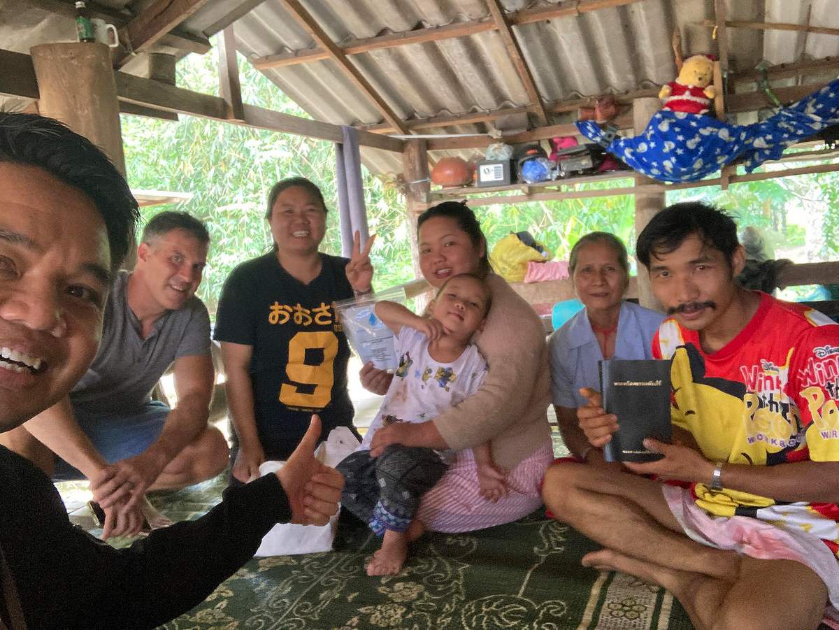 A family gathers to pray in their home