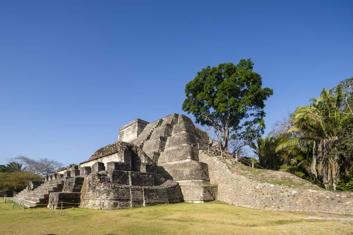 Ancient Maya temple ruins under a blue sky in Belize