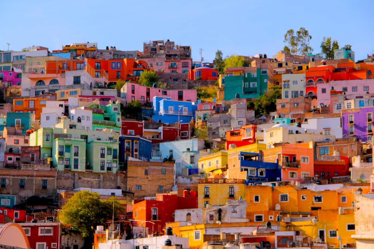 Brightly painted houses climb a hillside in Mexico