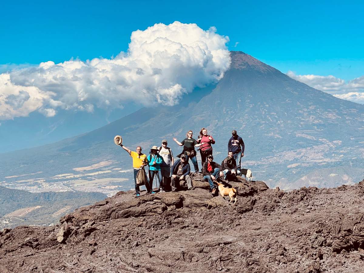 A mission team cheers on the slopes of Pacaya Volcano in Guatemala