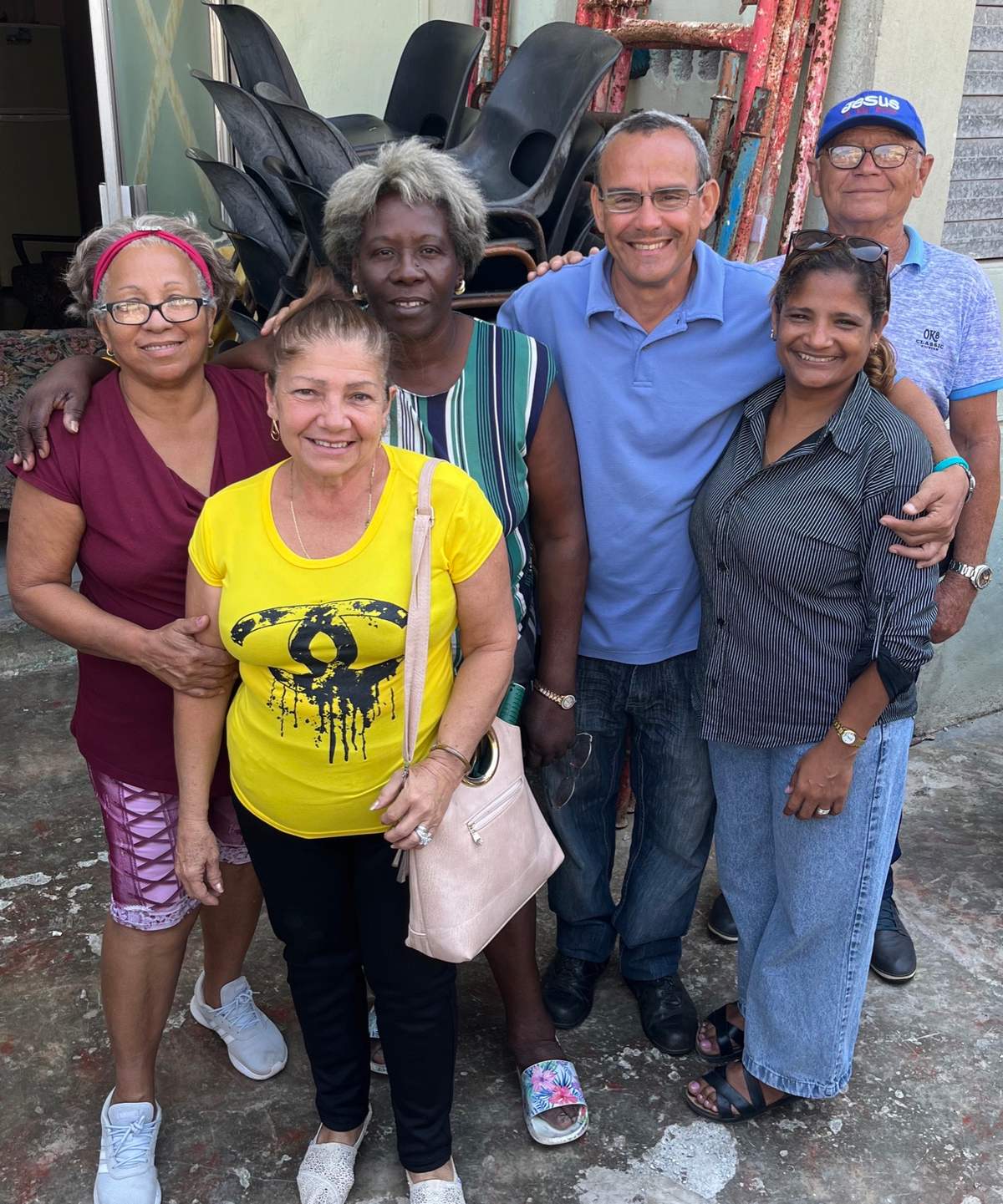 Church members and a pastor stand together in their neighborhood
