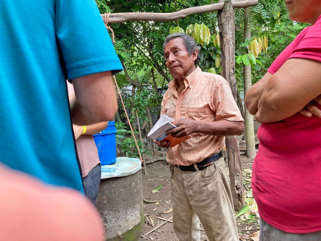 A Salvadoran man listens intently to the gospel being shared.