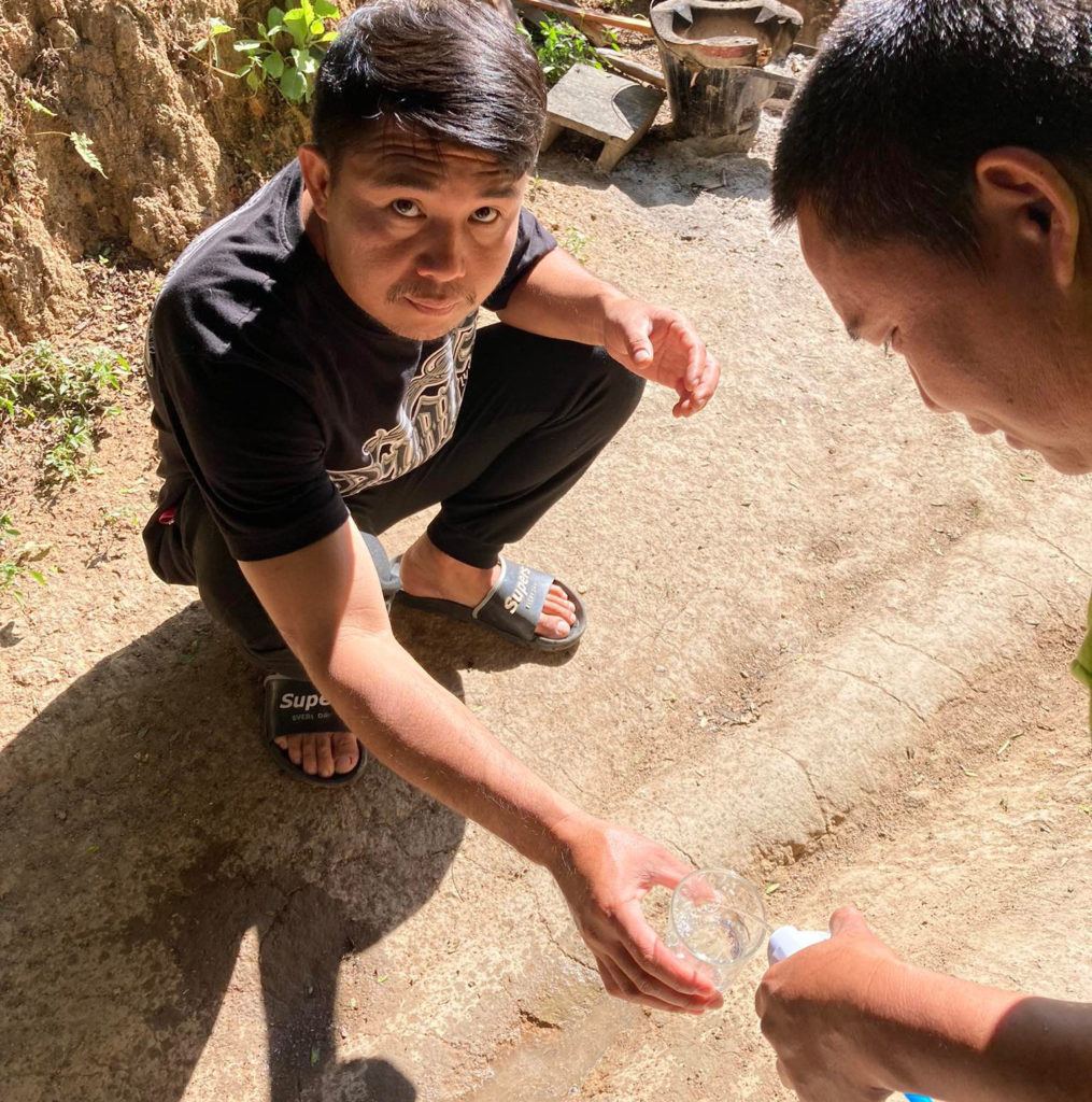 Man squatting for clean water